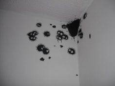 black moldy walls in a white room with holes and splatters on the wall