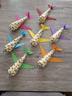 some food is laying out on a table with paper streamers in the shape of airplanes