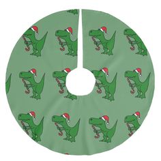 a green christmas tree skirt with an image of a dinosaur wearing a santa hat