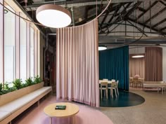 the interior of an office building with pink curtains