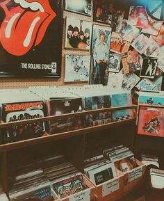 the rolling stones memorabilia is on display in a store with posters and cd's