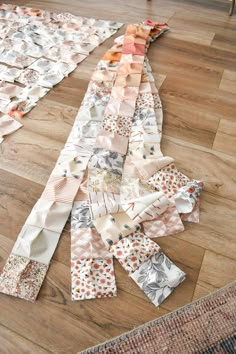 several pieces of fabric laid out on the floor to make a quilted table runner