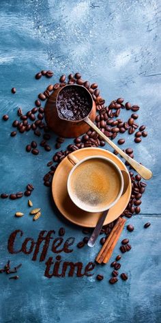 two cups of coffee and spoons on a blue surface with the words coffee time written in it