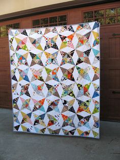 a large quilt hanging from the side of a garage door