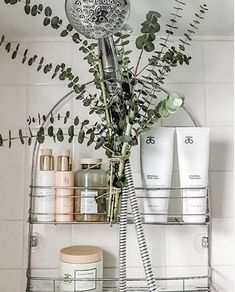 a bathroom shelf filled with lots of different types of skin care products and flowers on top of it