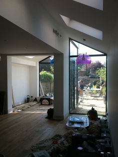 an empty room with lots of clutter on the floor and open doors leading outside