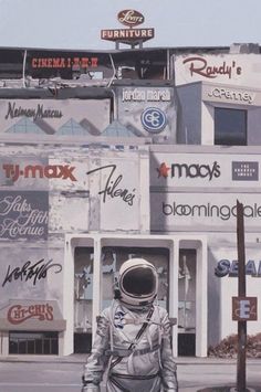 an astronaut standing in front of a building with many advertisements on it's side