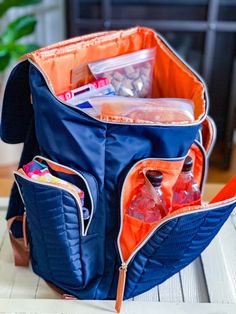 an orange and blue back pack sitting on top of a table