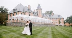 a bride and groom standing in front of a large building with a glass greenhouse on the lawn