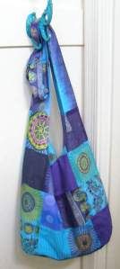 a blue and purple bag hanging on a door