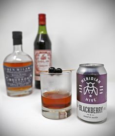 three different types of alcoholic beverages on a white surface