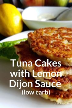 two cakes with lemon dijon sauce are stacked on top of each other, and the words tuna cakes with lemon dijon sauce low carb