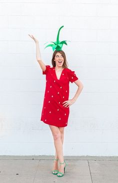 a woman wearing a red dress and a green pineapple on top of her head