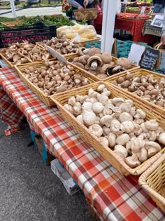 baskets filled with mushrooms sitting on top of a table