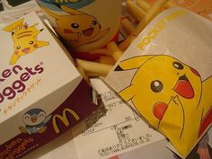 a close up of food on a table with french fries and a box of mcdonald's chicken nuggets