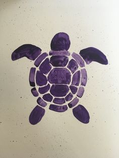 a drawing of a purple sea turtle on white paper with black dots in the background