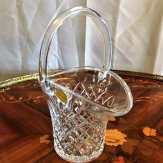 a glass basket sitting on top of a wooden table