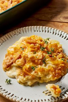 a white plate topped with food next to a casserole dish