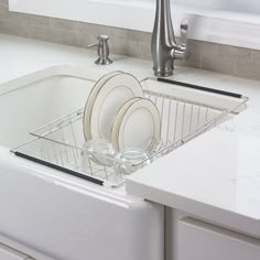 a kitchen sink filled with dishes and silverware