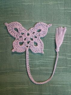 a crocheted butterfly with a tassel attached to it's back end