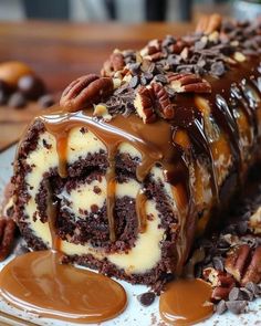 a piece of chocolate cake with pecans and caramel drizzle on top