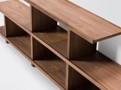 a wooden shelf with three shelves on one side and two open ones on the other