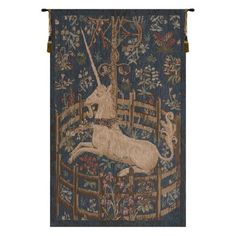 an animal tapestry hanging on the side of a wooden wall next to a white horse