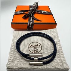 Hard To Find Colorbrand New Hermes Tournis Tresse Bracelet, Navy, Size T5, Palladium-Plated Hardware With Swift Calfskin. Made In Italy. Braid Width 0.12. Comes With Original Box, Ribbon, And Dust Bag. No Refunds After Purchase. Men Hermes Bracelet, Hermes Men Bracelet, Hermes Ring, Hermes Bracelet, Box Ribbon, Wrap Bangles, Hook Bracelet, Stockholm Style, Hermes Accessories