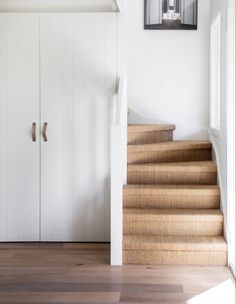 the stairs in this house are made of wood and have been painted with white paint