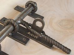 an old metal lock and key on a wooden surface