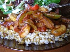 a plate with rice, meat and vegetables on it