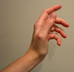 a person is holding their hand up in the air to catch something with his fingers