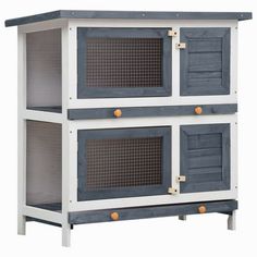 a white and blue cabinet with two doors on the front, one door open to reveal an animal cage