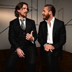 two men in suits sitting next to each other