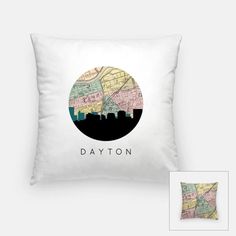 a white pillow with the word daytona on it and a black circle in the middle