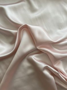 a close up view of a pink satin fabric