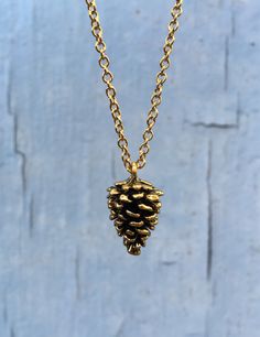 "Gold Pine Cone Necklace | Simple Pinecone Charm | Natural Minimalist Layering Necklace | Holiday Gift for Her This three dimensional pinecone is full of  charm. Gold plated over lead-free pewter with an antique finish. Chain is gold plated stainless steel, 18\" long with lobster clasp.  A sweet gift for a nature lover... And a perfect fit all year long! Necklace will arrive in a kraft style gift box. See more from my shop at https://www.etsy.com/shop/Stitches2Stones" Pine Cone Necklace, Pinecone Necklace, Necklace Simple, Sweet Gifts, Layering Necklace, Pine Cone, Minimalist Necklace, Simple Necklace, Antique Finish