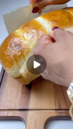 a person is cutting up a loaf of bread