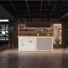 an empty room with a counter and shelves on the wall in front of it is lit by lights