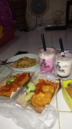 there are many different food items on the table together, including fried chicken and ice cream