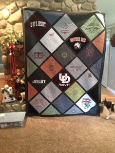 a quilt made to look like it is on the floor in front of a fireplace