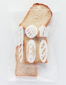 a piece of bread that has been cut in half and is sitting on top of a plastic bag