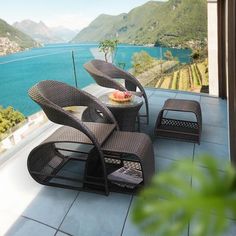 an outdoor patio with chairs and tables overlooking the water's edge, is shown in this image