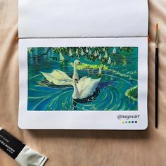 a white swan floating on top of a body of water next to a marker pen