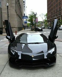 a black and white lamb car parked on the street