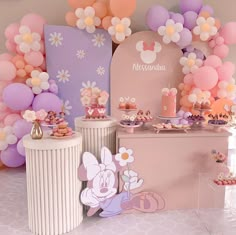 the dessert table is set up with balloons and other decorations for a minnie mouse themed birthday party