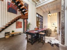 an open floor plan with stairs leading up to the second floor and dining room area