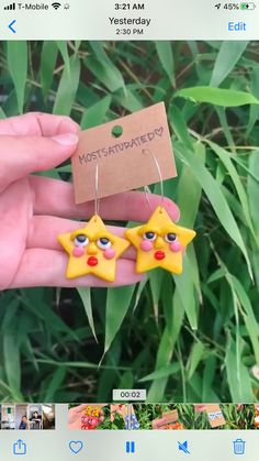 two yellow stars are hanging from a pair of earrings