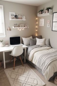 a small bedroom with a bed, desk and computer on the wall in front of it