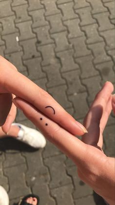 two people holding out their fingers with smiley faces on them